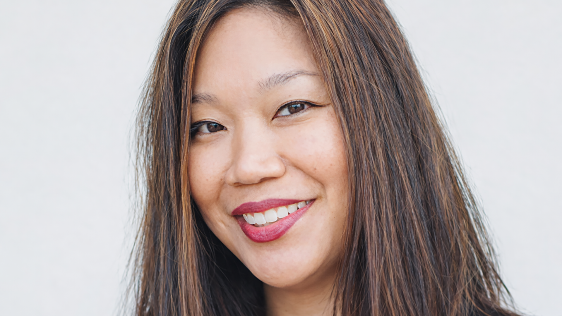 A woman with brown hair smiling